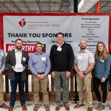 A group of people standing in front of a banner