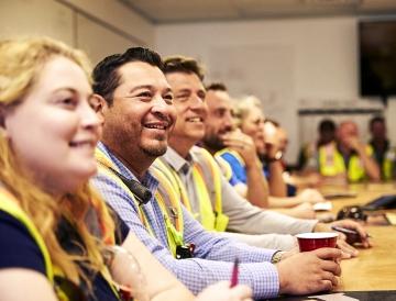 smiling employees at a meeting