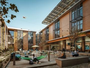 People enjoying a courtyard area at a student housing facility