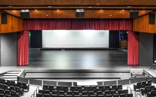 A performance hall with a stage and theater seating.