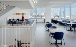 An open area with tables and chairs for lounging or studying. 