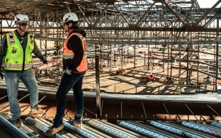 Construction workers having a conversation on a jobsite.